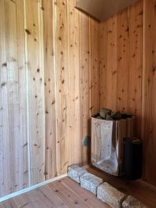a corner of a room with wooden walls at プライベートサウナでととのうpono 118は今帰仁村にあるお庭付き一棟貸 in Nago