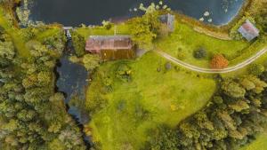 an overhead view of a house in the middle of a forest at Jeiskas dzirnavas in Launkalne