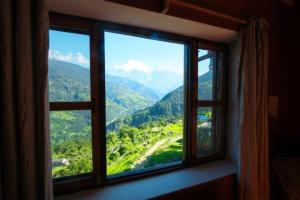 a window with a view of a mountain view at Mahakaruna mountain villa, peaceful family retreat with Himalayan views and Private Cook in Pokhara