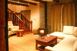 a living room with a couch and a fireplace at Mahakaruna mountain villa, peaceful family retreat with Himalayan views and Private Cook in Pokhara