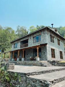 a large stone house on top of a hill at Mahakaruna mountain villa, peaceful family retreat with Himalayan views and Private Cook in Pokhara +40 photos