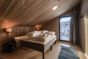 En eller flere senge i et værelse på Kikut Alpin Lodge 1302