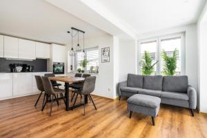 a living room with a table and chairs and a couch at homy Central City Oasis in Dornbirn in Dornbirn