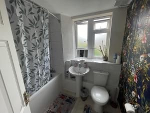 a bathroom with a sink and a toilet and a window at Family Friendly 3 Bedrooms Flat in Central London in London +47 photos