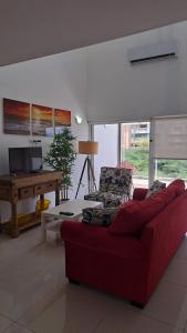 a living room with a red couch and a table at An oasis in the bay in Blue Bay