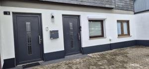 a pair of doors on the side of a house at Mitten im Sauerland in Finnentrop