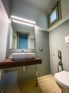 a bathroom with a sink and a mirror at isola felice residence - Family Apartment in Trapani