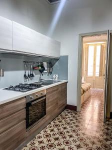 a kitchen with a stove top oven in a room at isola felice residence - Family Apartment in Trapani