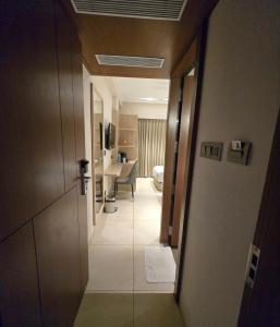 a hallway of a hotel room with a bathroom at Aarambh By The Sky Imperial Indore in Indore