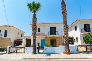 a row of palm trees in front of a house at 4 Bedroom Villa With Private Pool in Maroni