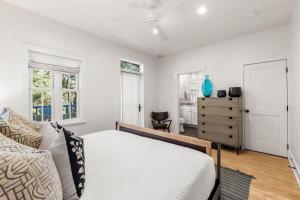 a bedroom with a bed and a dresser at The Last Waltz in Seacrest +77 photos
