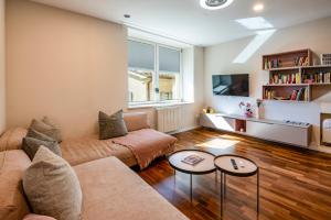 a living room with a couch and a table at CameliaLoft in San Marino