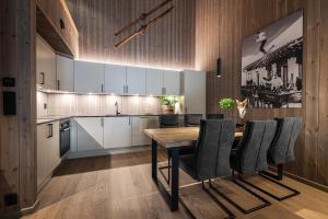 una cucina con tavolo e sedie in legno di Penthouse with large rooftop terrace, Ski In-Ski Out in Hemsedal a Hemsedal