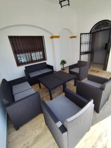a living room with couches and tables and a window at Casa Abuela Mercedes & Catalina in Hornachuelos
