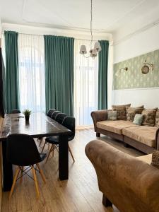 a living room with a couch and a table at Royality Bucharest Old Town in Bucharest