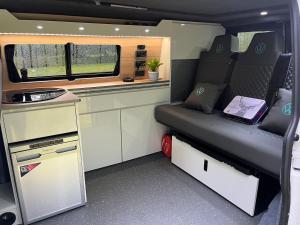 a small room with a bed in an rv at Campervan Scotland, Ben Roamer in Dunblane