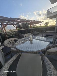 a table with chairs and a candle on a patio at Luxuriöse Ferienwohnung in Manavgat ilica in Ilıcaköy