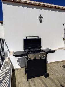 a barbecue grill sitting on top of a patio at Casa Abuela Mercedes & Catalina in Hornachuelos