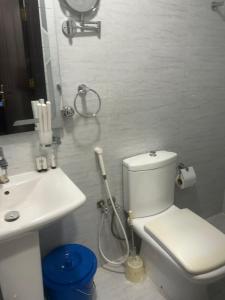 a white bathroom with a toilet and a sink at رميدا 3 in Abha