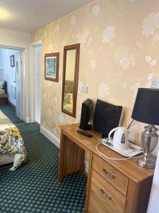 a hotel room with a desk with a computer on it at Near Hylands hotel family room in Nottingham