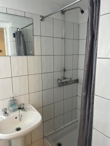 a bathroom with a sink and a mirror and a shower at Near Hylands hotel family room in Nottingham