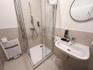 a bathroom with a shower and a sink at Charmantes Apartment in perfekter Lage mit kostenlosem Parken in Celle +9 photos