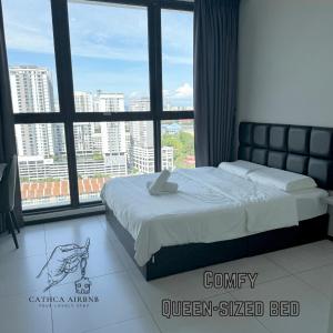 a bed in a room with a large window at Urban Suites Studio #SelfCheck-In #PrivateSpace in Jelutong
