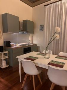 a kitchen with a white table with chairs and a counter at Il Palco Centrale in Tolentino +47 photos