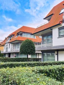 an apartment building with an orange roof at Cosy Corner 4 in Nieuwpoort