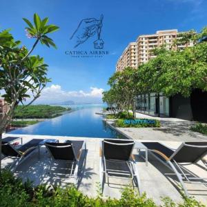 a view of a river with chairs on a walkway at Urban Suites Studio #SelfCheck-In #PrivateSpace in Jelutong +65 photos