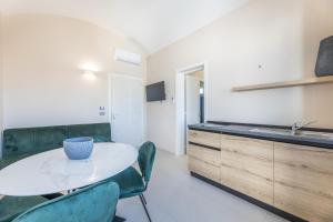 a kitchen with a table and chairs and a sink at Dimora Suite Idro in Gallipoli +10 photos