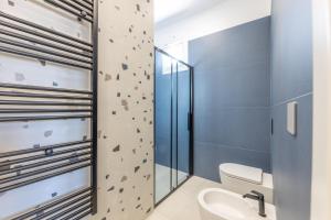 a bathroom with a rock climbing wall next to a toilet at Dimora Suite Idro in Gallipoli