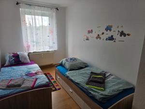 a bedroom with two beds and a window at Ferienwohnung Wagner in Neustadt