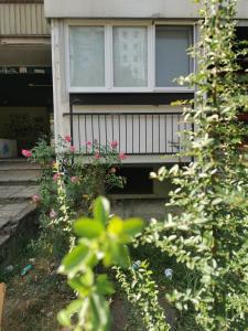 a house with a balcony with flowers in front of it at Andrej 62 in Beograd