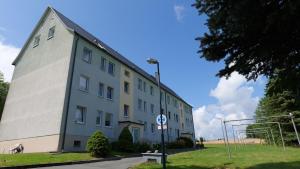 a large white building on the side of a street at Ferienwohnung Wagner in Neustadt +13 photos