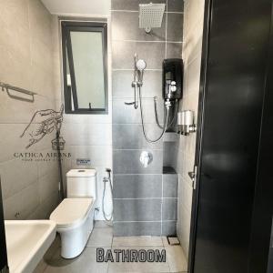 a bathroom with a shower and a toilet and a sink at Urban Suites 2BR #SelfCheck-in #6Pax #TopFacilities in Jelutong