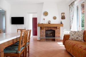 a living room with a table and a fireplace at Casa Vacanza al Capriano in Cantello