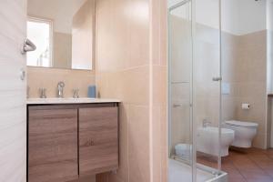 a bathroom with a toilet and a sink and a shower at Casa Vacanza al Capriano in Cantello +28 photos