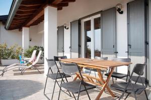 a wooden table and chairs on a patio at Casa Vacanza al Capriano in Cantello