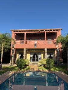 a house with a swimming pool in front of it at Dar Jabal in Aït Zat