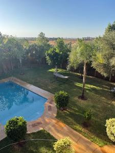 a backyard with a swimming pool and trees at Dar Jabal in Aït Zat +39 photos