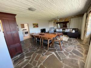 a living room with a wooden table and a couch at Klipwerf in Struisbaai