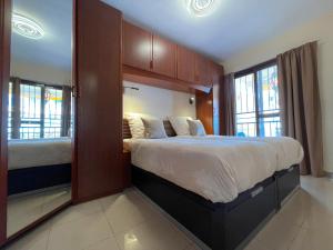 a bedroom with a large bed and two windows at Viva Tenerife in Costa Del Silencio