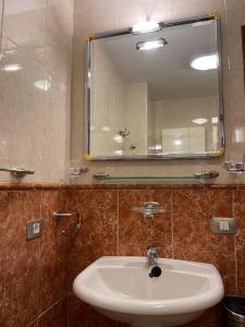 a bathroom with a sink and a mirror at Viva Tenerife in Costa Del Silencio