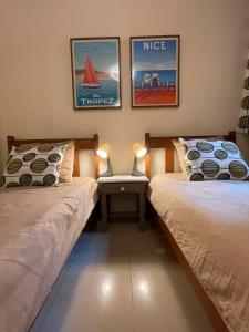 a bedroom with two beds and a table with a laptop at Viva Tenerife in Costa Del Silencio