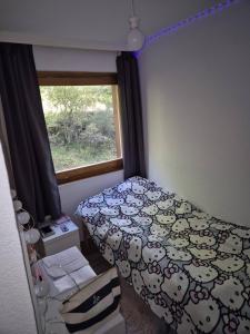a small bedroom with a bed and a window at Apartment with incredible views in Zinal +2 photos