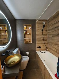 a bathroom with a sink and a toilet and a tub at Apartment with incredible views in Zinal