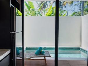 a room with a view of a swimming pool through a glass door at LM Home 2 Mendira in Candidasa