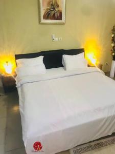 Voodi või voodid majutusasutuse Résidence La Paix Yamoussoukro, L'Oasis toas