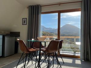 a table and chairs in front of a large window at Steall Gorge - Uk50495 in Kylestrome